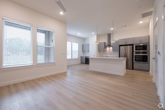 1BR, 1.5BA - 812SF - Living room, Kitchen, Dining Room - Oasis at Woodland