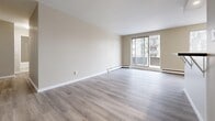 Located at 810 Exmouth St in Sarnia, Ontario, this well-appointed 2-bedroom, 1-bathroom unit offers a clean, modern living environment across a single floor. Consistent light-toned vinyl plank flooring flows throughout the space, creating a cohesive and easy-to-maintain interior. Neutral warm beige walls and crisp white trim contribute to a bright, welcoming ambiance.

The open-concept living room is generously sized, bathed in natural light through a large sliding glass door that leads to a private balcony — an ideal spot to enjoy outdoor views. The kitchen features white shaker-style cabinetry, dark granite-look countertops, stainless steel appliances, and a peninsula that provides additional counter space and storage, seamlessly connecting to the living area.

Both bedrooms are well-proportioned, each featuring windows that bring in natural light, baseboard heating, and neutral finishes. The primary bedroom is a comfortable size, and at least one bedroom includes a built-in closet with bi-fold doors for convenient storage.

The bathroom is finished with large-format neutral tile on both the floors and walls, a full soaker tub with an overhead shower, and modern fixtures, offering a clean and functional design. Overall, this unit presents a refreshed, move-in-ready living space in a practical Sarnia location.