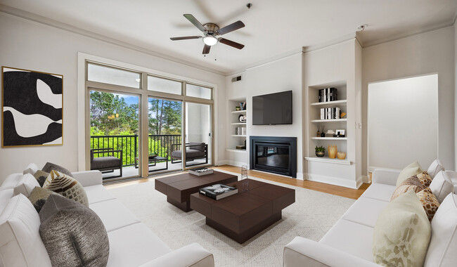 Living room with wood flooring and patio access - Tremont Apartments