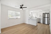 Located at 900 Phillips Street in Vista, CA, this thoughtfully updated single-story home offers 2 bedrooms and 2 bathrooms across a well-organized floor plan. Light-toned hardwood-style flooring runs throughout, creating a cohesive and airy feel in every room. The open living area greets you with a bold dark front door, multiple windows with modern blinds, and a sleek ceiling fan that enhances the bright, clean atmosphere. The kitchen is a standout feature, showcasing white shaker cabinetry with matte black hardware, marble-look countertops and backsplash, and a full suite of stainless steel appliances including a range, microwave, dishwasher, and refrigerator. The spacious primary bedroom provides ample room and includes access to a dedicated closet. Both bathrooms are finished in a contemporary style with white vanities, marble-look countertops, matte black fixtures, and framed mirrors. One bathroom features a tub-shower combination. Additional closets throughout the home offer generous storage. The consistent use of crisp white walls, light flooring, and black accent hardware gives the entire space a cohesive, modern aesthetic well-suited for comfortable everyday living.