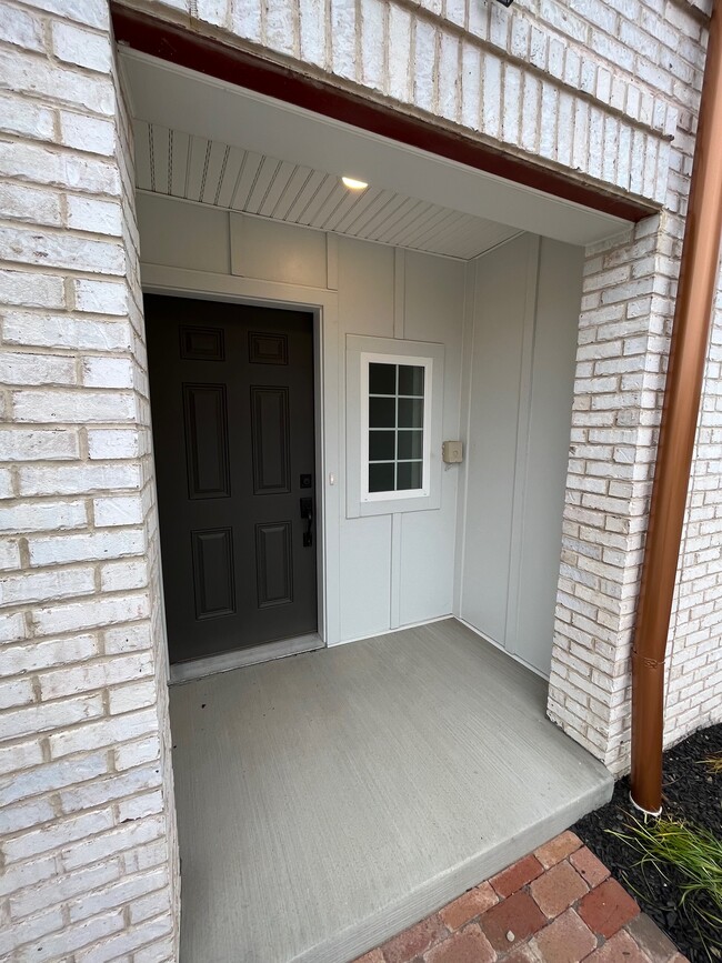 The front door includes a front porch. - 119 Founders St