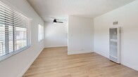 Located at 11635 Downey Avenue in Downey, CA, this single-story, one-bedroom, one-bathroom unit offers a well-organized and functional layout across its single floor. Light wood laminate flooring runs throughout, creating a warm, cohesive aesthetic that ties each room together seamlessly.

The living room is bright and open, featuring a ceiling fan with light fixture and a window fitted with blinds that allows natural light to fill the space. Clean white walls and a textured ceiling complete the clean, minimal look. The layout flows naturally into a hallway that connects the remaining rooms.

The kitchen is equipped with stainless steel appliances, including a full-size refrigerator and a gas range, set against white cabinetry and walls — a practical setup for everyday cooking needs.

The bedroom is a comfortable size, featuring a mirrored sliding closet door that adds depth and reflects light, enhancing the sense of space. A ceiling fan provides climate comfort, and the room connects conveniently to the hallway.

The bathroom has been updated with a white vanity topped with a speckled granite countertop, a framed rectangular mirror, and black matte hardware accents including a towel ring and door knobs — providing a contemporary contrast to the otherwise neutral palette. The six-panel interior doors and clean finishes throughout reflect a cohesive, move-in-ready condition.