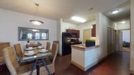 Located at 1201 Albert Ave in Midland, Texas, this single-story residence offers a thoughtfully designed layout with cohesive finishes throughout. Rich dark hardwood-style flooring flows through the main living areas, anchoring an inviting and consistent aesthetic.

The open-concept kitchen is equipped with dark espresso cabinetry, granite countertops, black appliances, and a peninsula that connects seamlessly to the dining area. The dining space is accented by a pendant light fixture and framed wall mirror, creating an intimate yet functional setting for meals.

The living room is generously sized, featuring multiple windows that allow ample natural light to fill the space. A ceiling fan overhead and direct access to an exterior door enhance comfort and convenience.

The bedrooms are carpeted for warmth and comfort, each with ceiling fans and windows with blinds. The primary bedroom is spacious enough to accommodate a king-sized bed and offers direct access to its own bathroom.

The bathrooms are finished with dark cabinetry and granite countertops. The primary bath features a dual-sink vanity with a large mirror and a glass-enclosed shower, while the secondary bath offers a single-sink vanity and a shower-tub combination. The kitchen corridor provides additional counter and storage space, completing this well-equipped residence.