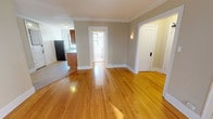 Located at 1001 Emerson St in Evanston, IL, this single-floor residence blends classic architectural character with functional living spaces. Rich hardwood floors run throughout the main living areas, complemented by crisp white crown molding that adds a refined, timeless appeal. The spacious living room is a standout feature, boasting a curved bay window with multiple panes that flood the room with natural light and offer views of the surrounding neighborhood. A cast-iron radiator underscores the home's classic character while providing efficient warmth. The bedroom features a ceiling fan, wide windows with neighborhood views, and the same warm hardwood flooring found throughout. A second room, accented by crown molding and a traditional radiator, offers flexibility as an additional bedroom or home office. The galley-style kitchen is well-appointed with warm wood cabinetry, granite countertops, stainless steel appliances including a gas range, built-in microwave, and full-size refrigerator, plus a window that brings in natural light. The bathroom is clean and functional, featuring tile flooring, a tub-shower combination with white tile surround, a vanity with ample storage, and a natural light window. Overall, the space exudes a warm, classic Evanston charm throughout.
