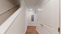 Located at 800 Federal Rd in Brookfield, Connecticut, this well-appointed two-floor residence blends modern finishes with a clean, functional design. The main level showcases an open-concept living and dining area bathed in natural light from multiple double-hung windows, all set atop warm hardwood-style flooring. Crown molding and recessed lighting add a refined touch throughout.

The kitchen is a standout feature, boasting crisp white shaker cabinetry, dark granite countertops, a classic white subway tile backsplash, stainless steel appliances, and a peninsula with pendant lighting — ideal for both everyday living and entertaining. A door from the kitchen provides convenient exterior access.

Two bathrooms serve the home: one features a walk-in shower with glass doors and a white vanity, while the second includes a full tub-shower combination, a white vanity with marble-style countertop, and hardwood-style flooring. A utility hallway on the main level provides additional storage and houses the electrical panel.

The upper floor features a generously sized bedroom with vaulted ceilings, plush carpeting, and a large window with views of the surrounding neighborhood. The space throughout is move-in ready, reflecting new construction quality with thoughtful attention to detail.