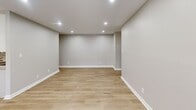 Located at 1710 Davenshire Road in Hauppauge, NY, this thoughtfully renovated one-bedroom unit offers a clean, modern aesthetic throughout its efficiently designed single-floor layout. A welcoming entry hallway with light wood-look flooring and recessed lighting leads into the main living areas, setting a bright and neutral tone carried throughout the space.

The kitchen is a standout feature, outfitted with crisp white shaker-style cabinetry, light granite countertops, a stainless steel sink, and a full suite of stainless steel appliances including an electric range, microwave, dishwasher, and refrigerator. The kitchen flows seamlessly into the open living area, which is illuminated by recessed lighting and features light hardwood-style flooring, baseboard heating, a wall air conditioning unit, and multiple windows that invite natural light from the exterior.

The generously sized bedroom offers a comfortable, quiet retreat with plush wall-to-wall carpeting, a ceiling fan with light fixture, a window with natural light, and multiple closets providing ample storage. The overall design palette — soft gray walls, white trim, and warm flooring — creates a cohesive, move-in-ready environment that is both functional and inviting.