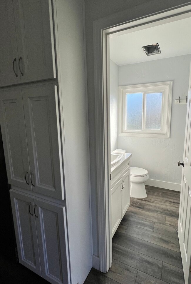 Hallway Storage and Bathroom with window, sink, toilet, and full size stand up shower. - 4960 34th St