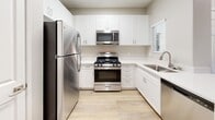 This 600-square-foot, one-bedroom, one-bathroom apartment at 25335 Alessandro Blvd in Moreno Valley, CA offers a well-designed single-floor layout with modern finishes throughout. Light wood-style flooring flows consistently through every room, complemented by neutral gray walls and crisp white trim, creating a clean and cohesive aesthetic.

The open-concept kitchen and living area is a functional centerpiece of the home. The kitchen features white shaker-style cabinetry, light quartz countertops, a stainless steel refrigerator, gas range, built-in microwave, dishwasher, and a single-basin sink. A skylight adds additional brightness to the space.

The living room is spacious and airy, equipped with a ceiling fan and access to a private balcony through sliding glass doors, allowing for natural light and outdoor views. The 170-square-foot bedroom also includes a ceiling fan, two windows with outdoor views, and its own sliding door access to the balcony.

The walk-in closet provides ample storage with multi-tiered wire shelving and hanging rods. The bathroom is outfitted with a full tub-shower combination with white tile surround, chrome fixtures, built-in open shelving, and matching wood-style flooring for a seamless look throughout the unit.