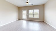 Located at 100 Star Blvd in Nashville, TN, this two-story, 3-bedroom, 3-bathroom home offers a well-designed layout spread across two floors. The main level features an open-concept kitchen and living area with light hardwood-style flooring throughout. The kitchen is a standout, boasting rich dark wood cabinetry, granite countertops, a subway tile backsplash, stainless steel appliances including a range, microwave, and dishwasher, and a peninsula with pendant lighting — ideal for both everyday cooking and entertaining. The living room is bright and airy, with large windows, a ceiling fan, and direct access to the outdoors. Three bathrooms are thoughtfully distributed throughout the home; one features a dark wood vanity with granite countertop and a tiled shower-tub combination with wood-look flooring, while another is a compact, clean half-bath. The three bedrooms are carpeted and filled with natural light from large windows, each equipped with a ceiling fan. The vaulted ceiling in the primary bedroom adds an elevated sense of space. Additional conveniences include a dedicated laundry area, hallway, and two closets. The home's neutral warm-toned palette and clean finishes create a bright, welcoming atmosphere throughout.