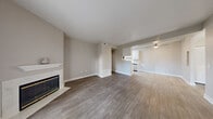 Located at 770 W Lone Mountain Rd in North Las Vegas, this 2-bedroom, 2-bathroom residence offers a well-designed, single-floor layout with a comfortable and functional living experience. The open-concept living, dining, and kitchen area serves as the heart of the home, showcasing warm wood-look flooring, neutral toned walls, and a tile-surround fireplace that anchors the living space. A sliding glass door floods the room with natural light and opens to a private balcony. The galley-style kitchen is equipped with stainless steel appliances, a gas range, white shaker cabinetry, light quartz-style countertops, and a skylight that adds brightness to the space. Both bedrooms are carpeted and generously sized, with the primary bedroom offering a large window with outdoor views. The unit includes five closets in total, providing exceptional storage capacity, including a walk-in closet with wire shelving. Each bathroom features a tub-shower combination, a vanity with stone-look countertops, and light flooring. Additional conveniences include an in-unit laundry area, a hallway connecting the private quarters, and a utility room. The overall ambiance is clean, bright, and move-in ready.