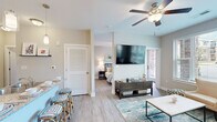 This thoughtfully designed one-bedroom, one-bathroom residence in Fayetteville, NC offers a comfortable and modern living experience across a single floor. The open-concept layout seamlessly connects the kitchen and living room, creating an inviting, functional space.

The kitchen is a standout feature, boasting white shaker cabinetry, granite countertops, a mosaic tile backsplash, stainless steel appliances, and a peninsula with bar seating — ideal for both cooking and casual dining. Pendant and track lighting add a polished touch overhead, while light wood-style flooring flows throughout.

The living room is bright and airy, with large windows that invite abundant natural light and offer outdoor views of the surrounding neighborhood. A ceiling fan overhead adds comfort, and the space is well-suited for relaxed everyday living.

The bedroom is a serene retreat with a ceiling fan, soft neutral tones, and French doors that open to an outdoor view, filling the room with natural light. The en-suite bathroom features a granite-topped double vanity with white cabinetry, a framed mirror, and a glass-enclosed shower. A dedicated walk-in closet with built-in wire shelving provides organized storage. Two hallways connect the spaces efficiently, completing this well-planned and move-in-ready home.