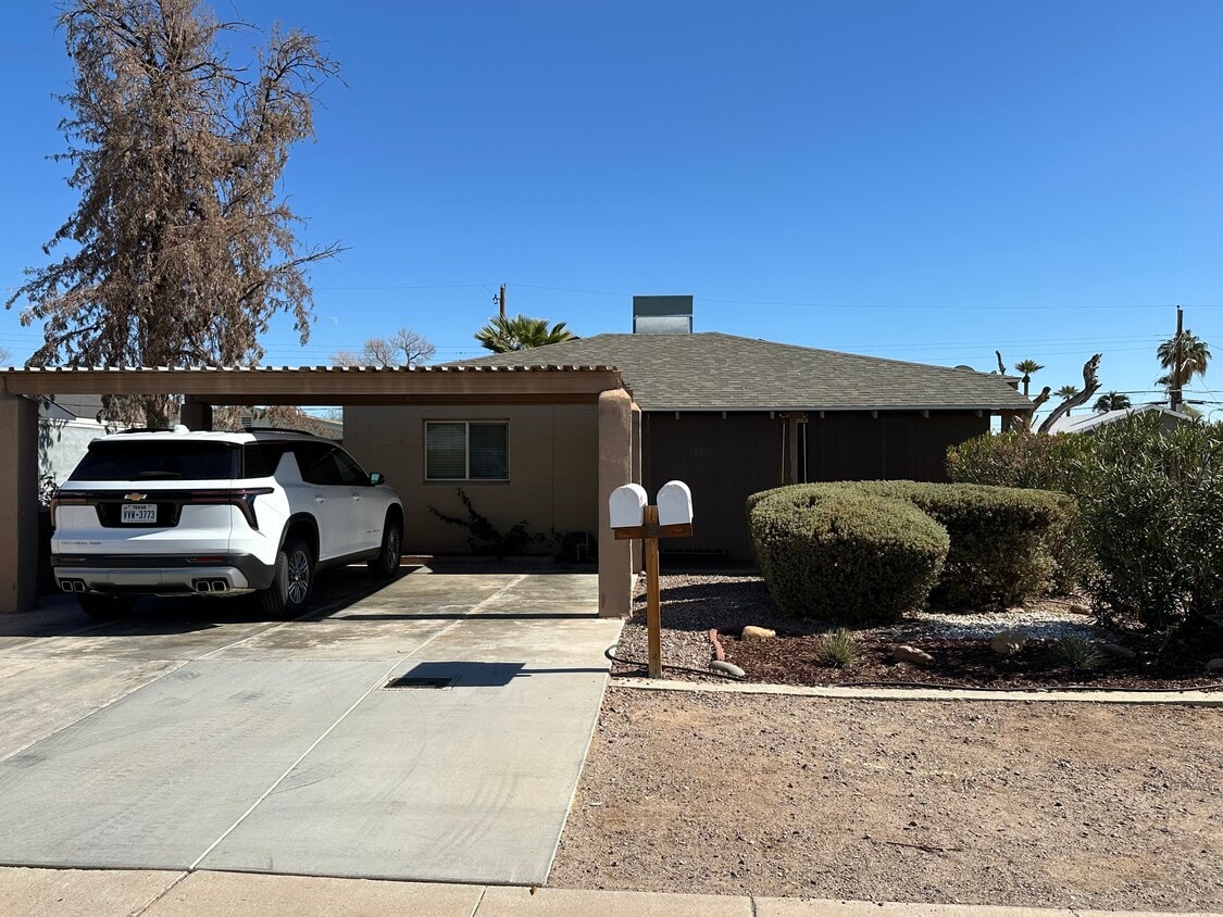 Front of house with two car carport and privacy landscaping/sunshades - 2513 N 28th St