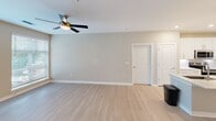 Located at 504 Jordan Pl in Charlotte's 28205 zip code, this well-appointed 2-bedroom, 2-bathroom home offers a thoughtfully designed single-floor layout with modern finishes throughout. The open-concept kitchen and living area serves as the heart of the home, featuring crisp white shaker cabinetry, quartz countertops, stainless steel appliances including a range, microwave, and French door refrigerator, and a kitchen island with pendant lighting. Light wood-look flooring extends through the main living spaces, complemented by neutral tones and a ceiling fan that adds comfort to the living room. The primary bedroom is a generous retreat with plush carpet, soft neutral walls, and direct access to a private en-suite bathroom. The primary bath includes a walk-in shower with large-format tile, a quartz-topped vanity with white cabinetry, and convenient access to a walk-in closet outfitted with wire shelving. The second bedroom is bright and comfortable, offering natural light through a sizable window with views of greenery. A second full bathroom features a tiled tub-shower combination and a matching vanity with stone countertop. Both closets are equipped with multi-tiered wire shelving systems, maximizing storage throughout.