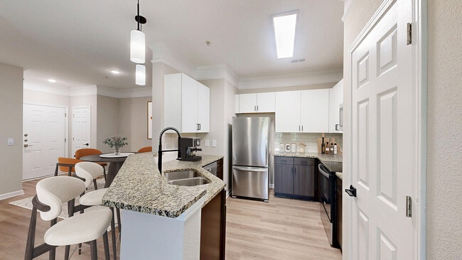 Newly Renovated Kitchen with Granite Countertops - Waterstone at Brier Creek Apartments