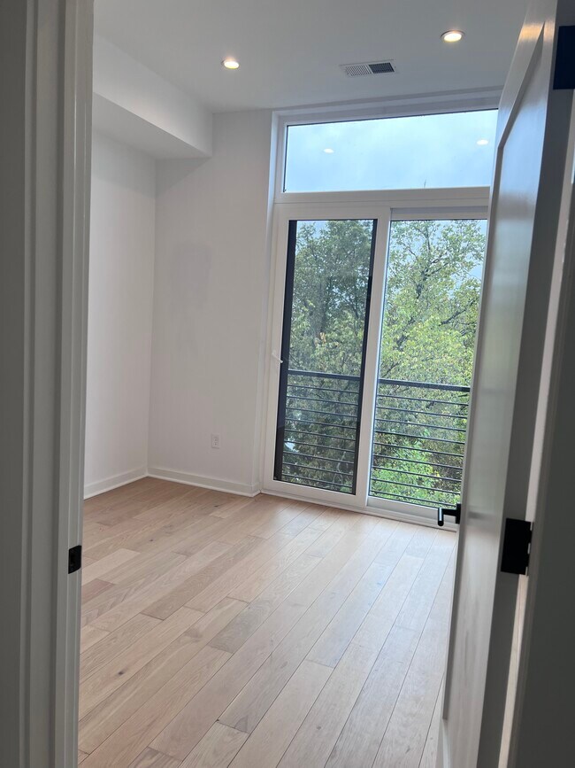 Spacious bedroom with full closet and juliet balcony. - 7700 Georgia Ave NW