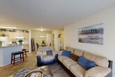 Located at 15235 O'Neal Rd in Gulfport, Mississippi, this single-story 2-bedroom, 2-bathroom home offers a well-designed layout with a smooth flow between living spaces. The open-concept living and dining area is finished with wood-look flooring and a textured ceiling, creating a warm and welcoming atmosphere. The living room receives natural light through a glass door, and connects seamlessly to the adjacent dining area, which features neutral wall tones and ample room for a dining set. The kitchen is well-appointed with light wood cabinetry, laminate countertops, and white appliances, including a range and refrigerator. A dedicated laundry area adds everyday convenience. Two hallways connect the private areas of the home, lined with decorative shelving and closet access. The spacious primary bedroom includes a generous walk-in closet with wire shelving. The second bedroom features carpet flooring and its own reach-in closet. Both bathrooms are clean and functional, each equipped with a tub-shower combination and wood-look tile flooring. With three closets total throughout the home, storage is plentiful. This residence offers a practical and comfortable living experience in a convenient Gulfport location.