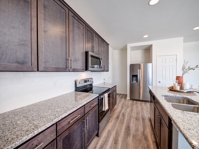 9278 Turlough galley kitchen has tons of storage and granite counterrops. - 9278 Turlough Hts