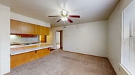 Located at 130 Cedar Creek Ct in Van Buren, Arkansas, this single-floor, 3-bedroom, 1-bathroom home offers a practical and functional layout. The open living area features neutral-toned carpet, a ceiling fan with light fixture, and a pass-through breakfast bar that connects seamlessly to the kitchen. The kitchen is equipped with warm wood cabinetry, white appliances including an electric range and dishwasher, a double-basin sink, and ample counter space along with a dedicated pantry area. Hardwood-style flooring runs throughout the kitchen and extends into the laundry area, which conveniently houses a full-size washer and dryer unit. Each of the three bedrooms is carpeted and features neutral walls, with the secondary bedrooms offering windows that allow natural light. The spacious primary bedroom includes access to a closet and hallway. Additional storage is provided by two closets throughout the home. The bathroom area features warm wood vanity cabinetry. Overall, the home presents a straightforward, well-organized floor plan suited for comfortable everyday living.