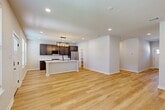 Located at 4097 General Pkwy in College Station, TX, this well-appointed two-story home offers a thoughtfully designed layout across two floors. The main level welcomes you through an entrance that opens into a bright living room featuring light hardwood flooring, recessed lighting, and a distinctive board-and-batten accent wall. The open-concept layout flows seamlessly into the dining area and kitchen, where rich dark cabinetry, crisp white quartz countertops, stainless steel appliances, a central island with pendant lighting, and a convenient adjacent pantry come together to create a functional and stylish culinary space. A garage with an automatic opener and a dedicated hallway round out the ground floor.

Upstairs, the carpeted staircase with a warm wood handrail leads to the upper level, which houses all four bedrooms, each with its own closet. The primary bedroom features plush carpet, a ceiling fan, and direct access to a private ensuite bathroom with dark vanity cabinetry and modern fixtures. The home's seven bathrooms are consistently finished with clean tile surrounds, matte black hardware, and dark wood cabinetry. Throughout, the home maintains a cohesive modern aesthetic with neutral tones and quality finishes.