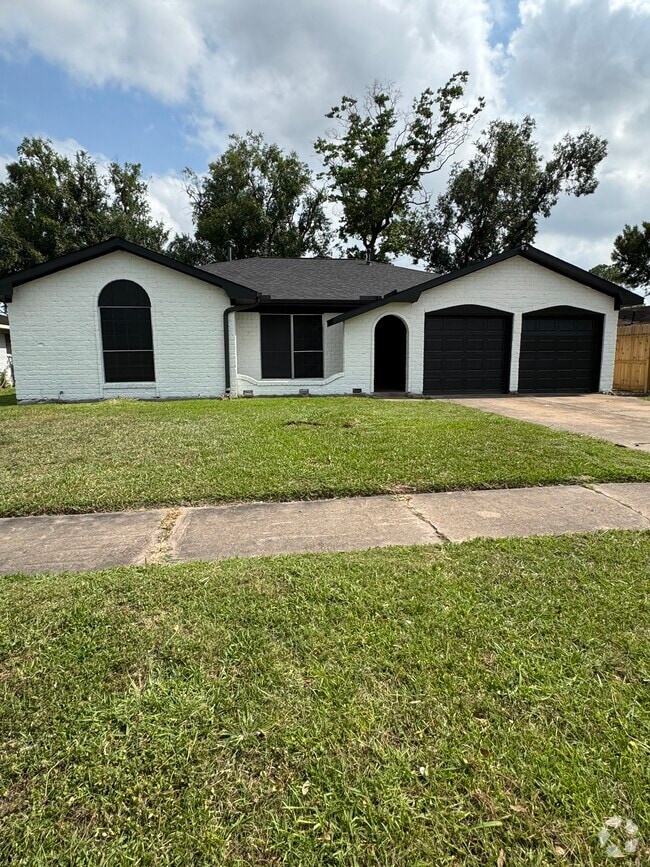 Freshly painted exterior with black accents and two-car garage curb appeal. - 11927 Troulon Dr