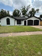 Freshly painted exterior with black accents and two-car garage curb appeal. - 11927 Troulon Dr