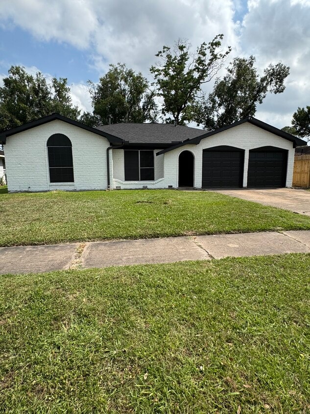 Freshly painted exterior with black accents and two-car garage curb appeal. - 11927 Troulon Dr