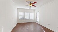 Located at 1309 Winkler Ave in Killeen, Texas, this single-story home offers a clean, modern interior with a cohesive design aesthetic throughout. The living area is a standout space, featuring rich wood-look flooring, crisp white walls with crown molding, and a ceiling fan with a light fixture that adds both function and character. Large windows dressed with white horizontal blinds allow generous natural light to fill the room, creating a bright and welcoming atmosphere.

The kitchen is well-appointed with dark espresso cabinetry providing ample upper and lower storage, light-toned countertops, and a full suite of black appliances including a refrigerator, electric range, and built-in microwave. A peninsula counter connects the kitchen to the adjacent living space, creating an open, functional layout. A doorway from the kitchen leads to a dedicated laundry area, adding practical convenience.

The bedrooms offer comfortable accommodations, with one room showcasing the same wood-look flooring and multiple windows, while another features plush neutral carpet and a window with natural views. The bathroom is finished with dark vanity cabinetry, a light countertop, a large mirror, wood-look flooring, and a tiled tub-shower combination, completing the home's consistent and practical design.