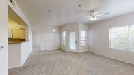 This single-floor residence offers a practical and comfortable layout designed for everyday living. The open living and dining area serves as the heart of the home, featuring neutral-toned carpet, a ceiling fan with light fixture, and multiple windows that allow natural light to fill the space. A glass-paneled door provides access to the exterior, enhancing the sense of openness. A pendant light fixture defines the dining zone within this shared space.

The kitchen is efficiently designed in a U-shaped configuration, equipped with light wood cabinetry, laminate countertops, and a full suite of white appliances including a refrigerator, electric range, over-the-range microwave, and dishwasher. Tile flooring ties the space together with a clean, easy-to-maintain finish.

The bedrooms are generously proportioned, each finished with soft wall-to-wall carpet, ceiling fans, and windows that invite natural light. The rooms offer a neutral palette, providing a versatile backdrop for a variety of interior styles.

Two full bathrooms serve the unit, both featuring tile flooring, vanities with ample cabinet storage, large mirrors, and tub-shower combinations. The layout is functional and well-organized, catering to both daily routines and guest needs. Overall, the unit presents a clean, move-in ready environment with a consistent, understated aesthetic throughout.