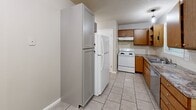 Located at 110 Biesecker Rd in Lexington, NC, this two-bedroom, two-bathroom home is spread across two floors, offering a practical and functional layout. The main floor houses the kitchen, which features warm wood cabinetry, granite-style countertops, a tile backsplash, and white appliances including a range, refrigerator, and dishwasher. Light tile flooring runs throughout the kitchen and extends into the adjacent dining area, which receives natural light through a sliding glass door. A dedicated laundry area is also conveniently located on this level.

The two bedrooms are carpeted with a patterned, multi-tone carpet and are finished in neutral gray tones with clean white trim. Each bedroom is equipped with a ceiling fan with light fixture and windows fitted with blinds that allow for natural light and privacy. One bedroom features a closet with double doors, while the primary bedroom offers additional space and multiple windows. The two bathrooms are finished with neutral tones, featuring a tub-shower combo with chrome fixtures and tile flooring. The overall ambiance of this home is clean, neutral, and move-in ready, providing a comfortable and low-maintenance living environment.