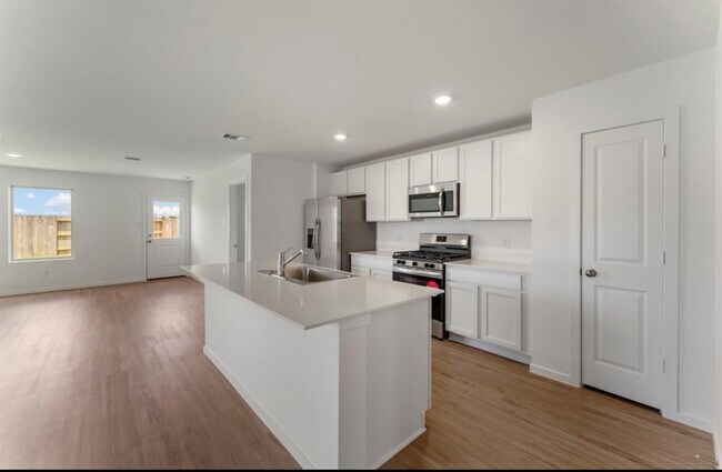 Cocina con isla abierta a la sala de estar. Incluye refrigerador. - 18602 Gravago Ln