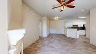 Located in the desirable Stone Oak neighborhood of San Antonio, TX, this well-appointed 2-bedroom, 2-bathroom residence offers a comfortable and functional single-floor layout. The open-concept living and dining area flows seamlessly into the kitchen, which is equipped with stainless steel appliances, white shaker cabinetry, dark granite countertops, a peninsula with a built-in sink, and a slate-toned subway tile backsplash — a clean, modern aesthetic that anchors the home. Light wood-style flooring extends throughout the main living spaces, complemented by neutral-toned walls and ceiling fans that add both comfort and character. The primary bedroom is a well-sized retreat featuring plush carpeting, a ceiling fan, and ample natural light from a large window. The second bedroom mirrors this comfort with carpet flooring and its own ceiling fan. Both bathrooms are finished with white cabinetry, granite-style countertops, and wood-look flooring, with the full bath including a tub-shower combination with white tile surround. A dedicated laundry room adds everyday convenience. Crown molding in select areas and abundant closet space throughout round out this thoughtfully designed residence. A private balcony offers an outdoor escape.