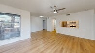 Located at 812 S Cooper Square Circle in Arlington, TX, this well-appointed 2-bedroom, 2-bathroom residence offers a thoughtfully designed single-floor layout with a clean, modern aesthetic. Light wood flooring extends throughout the entire unit, creating a warm and cohesive atmosphere from room to room. The open living area is a standout feature, anchored by a classic wood-burning fireplace and a ceiling fan, with sliding glass doors that lead to a private patio and allow natural light to fill the space. A pass-through opening connects the living area to the kitchen, which is equipped with stainless steel appliances, a gas range, and a tile backsplash. A dedicated pantry provides additional storage. The dining area flows naturally between the kitchen and living room, making the layout ideal for everyday living and entertaining. Both bedrooms feature light wood flooring, ceiling fans, and natural light from windows. The primary bedroom includes walk-in closet access and an en-suite bathroom. The bathrooms are finished with large-format tile surrounds and brushed nickel fixtures. Additional highlights include a dedicated laundry area, five closets for ample storage, and a textured ceiling detail throughout.