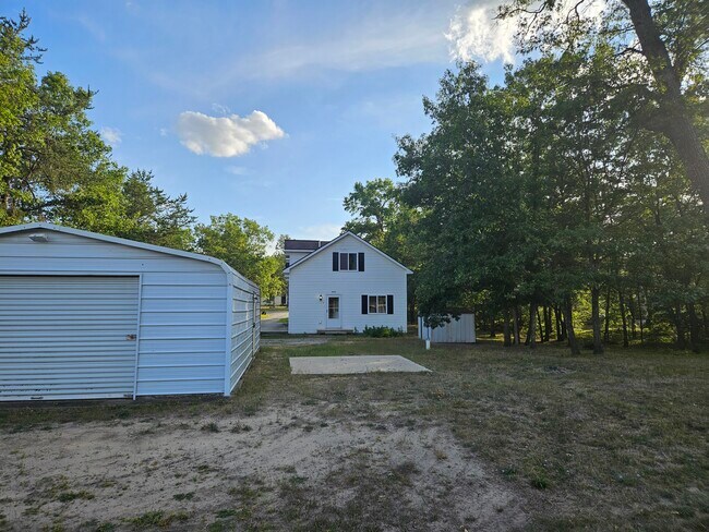 From the large back yard looking toward your unit. Notice the garage. It is available for use - 4304 Kateri Ln