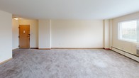 Located at 3955 N Murray Ave in the village of Shorewood, Wisconsin, this single-floor residence offers a practical and comfortable layout across several well-defined living spaces. The expansive living room features soft wall-to-wall carpeting, warm neutral tones, and a ceiling fan, creating a bright and open atmosphere. A built-in cabinet with glass-front doors adds a classic touch and provides convenient display and storage space.

The kitchen is efficiently designed with wood-trimmed white cabinetry, white laminate countertops, and a full suite of appliances including a coil-burner electric range, dishwasher, and a top-freezer refrigerator. A range hood and a deep single-basin sink round out the functional layout, while vinyl flooring adds easy maintenance underfoot.

The bedrooms are generously sized, each outfitted with plush carpeting, ceiling fans with light fixtures, and baseboard heating. Both rooms feature bifold closet doors — one bedroom offering a single closet and the other boasting a double closet configuration, providing excellent storage capacity.

The full bathroom is finished with light ceramic tile flooring, a wood-trimmed vanity, and a combined tub and shower. Clean, neutral finishes throughout create a cohesive and move-in ready environment suited for comfortable everyday living.