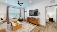Located at 13695 Lead Ln in Lady Lake, Florida, this single-story 2-bedroom, 2-bathroom home offers a thoughtfully designed layout with contemporary finishes throughout. Wood-look plank flooring flows seamlessly across the living areas, complemented by crisp white walls and recessed lighting that create a bright, clean aesthetic.

The kitchen serves as a central highlight, featuring floor-to-ceiling taupe cabinetry, a white subway tile backsplash, stainless steel appliances, and a granite-topped island with seating — ideal for casual dining or entertaining. The open living room is well-lit by large windows with outdoor views and includes a ceiling fan, offering a comfortable and airy atmosphere.

The primary bedroom is a serene retreat with large windows that bring in natural light, ceiling fan, and ample closet space. The en-suite bathroom includes a walk-in glass shower, granite vanity countertop, and matching taupe cabinetry. The second bedroom is equally inviting with its own ceiling fan and natural light. The second bathroom features a tub-shower combination and matching finishes. Additional spaces include hallways, three closets, a laundry area, utility room, and a patio — rounding out a practical and polished home.
