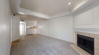 This well-appointed 2-bedroom, 2-bathroom single-floor residence at 11300 Expo Blvd in San Antonio, TX offers a thoughtfully designed layout with a cohesive, neutral color palette throughout. The living area features rich hardwood-style flooring and elegant crown molding, creating a polished ambiance that extends into the adjoining dining room. The dining space is framed by a pass-through window that connects directly to the kitchen, allowing for easy interaction and natural flow between rooms. The kitchen is finished with white cabinetry and tile flooring, offering a clean and functional workspace complemented by a dedicated pantry for added storage. Both bedrooms are generously proportioned, with the primary bedroom benefiting from multiple windows that invite natural light and views of the surrounding greenery. Each bedroom is served by its own walk-in closet with built-in shelving and hanging rods, providing ample storage. The bathrooms feature tub-shower combinations with tiled surrounds, wood-style flooring, and white vanity cabinetry. Additional highlights include multiple hallways for efficient circulation, a private patio for outdoor enjoyment, and three total closets throughout the unit, ensuring practical storage solutions across the entire residence.