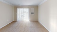 Located at 14431 Traville Garden Cir, Apt 214 in Rockville, Maryland, this single-floor apartment offers a functional and comfortable layout with well-defined living spaces. The kitchen is equipped with warm oak cabinetry providing ample storage, white appliances including a dishwasher, range, and refrigerator, and a double-basin sink. Light hardwood-style flooring anchors the kitchen area, which flows seamlessly into the carpeted living and dining space. Crown molding adds a refined touch to the living area, which benefits from natural light streaming through a large sliding glass door dressed with vertical blinds, opening to an outdoor view. The bedroom features neutral beige carpeting, soft-toned walls, and a window with blinds that allows natural light to brighten the room. The bathroom is appointed with a wood-toned vanity, a wide mirror, a single-basin sink with chrome fixtures, a toilet, and a walk-in shower with a curtain rod. Throughout the unit, neutral wall colors and consistent finishes create a clean, cohesive aesthetic. The overall ambiance is practical and move-in ready, well-suited for comfortable everyday living in a residential Rockville community.