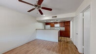 Located at 234 N 75th St in Mesa, Arizona, this single-story, one-bedroom, one-bathroom home offers a well-organized layout designed to maximize functionality. Wood-style flooring runs throughout the entire space, providing a cohesive and easy-to-maintain finish.

The open-concept living area flows directly into the kitchen, which is separated by a breakfast bar peninsula with granite-style countertops. The kitchen is well-equipped with rich cherry wood cabinetry offering ample storage, granite-style countertops, a full suite of white appliances including a refrigerator, electric range, built-in microwave, and dishwasher, as well as a stainless steel sink. Track lighting and recessed lights illuminate the kitchen area effectively.

Ceiling fans are present in both the living area and bedroom, aiding with air circulation. The bedroom receives natural light through a window with blinds and features two closets for generous storage. A dedicated laundry area adds further convenience.

The bathroom includes a cherry wood vanity with a granite-style countertop, an undermount sink, and a full tub-shower combination. Clean white walls and consistent wood-style flooring maintain a unified aesthetic throughout the home.