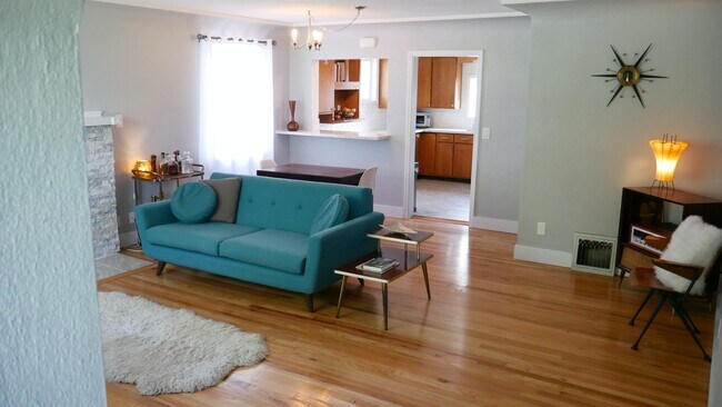 Spacious living room with mid-century feel and tall ceilings. - 218 E Walton Ave