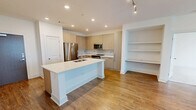 Located at 350 Village Drive in King of Prussia, PA, this well-appointed two-bedroom, two-bathroom residence offers a thoughtfully designed single-floor layout with a clean, modern aesthetic. The open-concept kitchen and living area serves as the heart of the home, featuring warm hardwood-style flooring, recessed lighting, light wood cabinetry, and a generously sized center island with a white quartz countertop and integrated sink — ideal for both everyday living and entertaining. Stainless steel appliances and a subway tile backsplash complete the contemporary kitchen.

Both bedrooms are carpeted for comfort, with the primary suite offering a spacious walk-in closet equipped with multi-level wire shelving for ample storage. The primary bathroom is elegantly finished with large-format marble-look tile flooring, a dual-sink vanity with wood cabinetry and quartz countertops, a soaking tub, and a separate glass-enclosed shower. The second bathroom mirrors the refined finishes with its own wood vanity, quartz countertop, and a walk-in glass shower. A second walk-in closet with wire shelving provides additional storage. Natural light flows throughout, with windows offering views of the surrounding community.