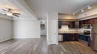 Located at 1003 Bluegrass Cir in Cedar Falls, Iowa, this single-floor, 2-bedroom, 2-bathroom residence offers a practical and comfortable layout with modern finishes throughout. The open living area features wood-style plank flooring, a textured ceiling, and a ceiling fan, with a sliding glass door fitted with vertical blinds that allows natural light to fill the space. The kitchen is a standout feature, showcasing rich dark cabinetry, light countertops, a full suite of stainless steel appliances including a refrigerator, range, microwave, and dishwasher, and track lighting overhead — all flowing seamlessly from the living area. Both bedrooms are carpeted and offer a quieter, softer feel, each with closet storage. The primary bedroom is generously sized and includes a window with outdoor views. The two bathrooms mirror each other in style, featuring dark wood vanities, light countertops, and wood-style flooring. One bathroom includes a walk-in shower, while the other offers a full tub-shower combination. A dedicated laundry area with washer and dryer hookups adds everyday convenience. The unit is rounded out by a closet for additional storage, making this a functional and move-in ready home.