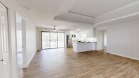 This contemporary apartment in Tucson, AZ, offers 990 square feet of thoughtfully designed living space. The open-concept layout seamlessly integrates the kitchen and living areas, creating an inviting atmosphere for both relaxation and entertainment. The kitchen is a standout feature, boasting pristine white cabinetry, sleek stainless steel appliances, and elegant granite countertops that extend to form a convenient breakfast bar.

Both bedrooms are generously sized, with the primary bedroom measuring an impressive 200 square feet. Each room is fitted with large windows that invite natural light, while modern ceiling fans ensure comfort. The two full bathrooms are tastefully appointed, featuring clean lines and a neutral color palette.

Throughout the apartment, warm wood-look flooring adds a touch of sophistication and ties the spaces together harmoniously. The in-unit laundry room, equipped with full-sized washer and dryer, offers added convenience. Additional amenities include ample closet space and stylish light fixtures.

The apartment's design emphasizes functionality without compromising on style, making it an ideal home for those seeking a balance of comfort and modern living in Tucson's desirable 85704 zip code.