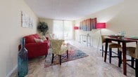 Located at 1915 Keystone Blvd in North Miami, Florida, this single-floor residence offers a well-organized layout with distinct living, sleeping, kitchen, and bathroom areas. The living room is an inviting, open space with large sliding glass doors that flood the room with natural light and provide access to an outdoor balcony with views of lush greenery. The tile flooring adds a clean, practical touch throughout the main living areas. The galley-style kitchen features warm wood cabinetry, granite-style countertops, a stainless steel sink, and ample storage, making efficient use of the space. The bedroom is generously sized, with plush wall-to-wall carpeting, a large window that brings in natural light, and a walk-in closet offering substantial storage. Two bathrooms serve the residence: one features a granite-topped vanity with wood cabinetry and decorative stone-tile flooring, while the second is a compact full bath with a shower-tub combination and tile flooring. Throughout the space, warm neutral tones on the walls create a cohesive and welcoming atmosphere. The overall layout is functional and comfortable, well-suited for everyday living in the vibrant North Miami area.