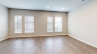 Located at 1001 W Rosedale St in Fort Worth, TX, this thoughtfully designed one-bedroom, one-bathroom unit offers a well-utilized, single-floor layout with modern finishes throughout. The open-concept living area seamlessly connects the kitchen, dining, and living spaces, all unified by light wood-look flooring and neutral-toned walls that create a bright, airy atmosphere. Multiple windows invite abundant natural light, particularly in the living area where several large windows provide views of the surrounding greenery.

The kitchen is a standout feature, showcasing warm wood cabinetry extending to the ceiling, a textured tile backsplash, granite countertops, and a central island with additional granite surface space. Stainless steel appliances, including a refrigerator, range, microwave, and dishwasher, complete the modern aesthetic. Pendant lighting above the island adds a stylish touch.

The bedroom is a serene, well-proportioned retreat with a window offering outdoor views and access to a walk-in closet with built-in shelving. The bathroom features wood-toned cabinetry with granite counters, floor-to-ceiling tiled walk-in shower with a frameless glass door, and wood-look flooring. A dedicated laundry room with a full-size washer and dryer adds everyday convenience.