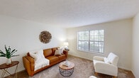 Located at 3351 Cove Lake Dr in Lexington, KY, this single-floor, one-bedroom, one-bathroom residence offers a smartly organized layout that maximizes every square foot. The carpeted living room is bright and welcoming, featuring a large window that frames outdoor greenery and fills the space with natural light. Adjacent to the living area, the dedicated dining room includes a stylish chandelier overhead and provides a comfortable setting for everyday meals. The kitchen is equipped with warm wood cabinetry, light countertops, a double-basin sink, a dishwasher, and an electric range, with tile flooring adding a practical touch. The spacious bedroom offers a window with outdoor views, soft carpet underfoot, and an impressive wall of louvered bi-fold closet doors providing exceptional storage capacity. A hallway and additional closets further enhance the home's organizational options. The bathroom features a wide vanity with wood cabinetry, a large mirror with Hollywood-style lighting, and clean white finishes throughout. A utility room rounds out the functional layout. With neutral tones, carpet throughout the main living areas, and a cohesive, understated design, this residence offers a comfortable and practical living environment.