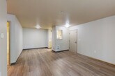 Located at 3111 132nd St SE in Everett, Washington, this single-floor residence offers four bedrooms and two full bathrooms within a efficiently designed layout. The open living, dining, and kitchen area serves as the heart of the home, featuring light wood-style laminate flooring, neutral white walls, and a pass-through window connecting the kitchen to the main living space. The kitchen is equipped with white appliances, including a range and microwave, along with warm-toned cabinetry. A central hallway with ceiling lighting connects the living area to the private bedrooms, maintaining a clear and functional flow throughout. The bedrooms are carpeted and finished in soft, neutral tones, with several rooms receiving natural light through windows with views of surrounding greenery. The primary bedroom provides a comfortable, well-proportioned retreat. Both bathrooms are well-appointed, each featuring a full tub-shower combo, toilet, and vanity with storage — one with elegant herringbone-patterned tile flooring and light wood cabinetry, and the other with wood-look tile and a speckled countertop. A dedicated closet adds practical storage. The consistent use of light finishes and neutral tones throughout creates a clean, cohesive aesthetic across the entire residence.