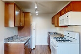 Located at 2554 Naylor Rd SE in Washington, DC, this two-bedroom, one-bathroom unit is part of a classic brick residential building surrounded by mature trees and well-maintained landscaping. The single-floor layout offers a practical and comfortable living arrangement throughout.

The living area is generously sized, featuring neutral-toned walls, plush wall-to-wall carpeting, and a ceiling fan overhead. A window allows natural light to fill the space, while a section of hardwood flooring near the window adds a subtle contrast to the carpeted areas.

Both bedrooms are carpeted and finished with the same warm neutral palette. Each room features windows that bring in natural light and views of the surrounding greenery. The spacious primary bedroom includes a closet with paneled doors, offering ample storage. The second bedroom is equally well-proportioned and bright.

The bathroom is clean and functional, featuring a full tub-shower combo with white tiled surround, a wood-vanity with a white countertop sink, and a mirrored medicine cabinet with built-in lighting above.

A private balcony extends the living space outdoors, offering pleasant views of the courtyard, walking paths, and the lush tree canopy that frames the brick building exterior — a serene retreat within the city.