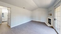 Located at 1000 Cirby Oaks Way in Roseville, CA, this well-appointed 1-bedroom, 1-bathroom unit offers a thoughtfully designed single-floor layout that maximizes every square foot. The living room serves as the heart of the home, featuring wood-style flooring, a classic white brick fireplace, and sliding glass doors that invite natural light and provide access to an outdoor area. The galley-style kitchen is efficiently organized with crisp white cabinetry, light countertops, recessed lighting, and black appliances, including a gas range and refrigerator, complemented by a window that brightens the workspace. A dining nook adjacent to the kitchen receives additional natural light through a street-facing window. The bedroom is a comfortable retreat featuring mirrored sliding closet doors that enhance the sense of space, soft neutral walls, and consistent wood-style flooring. A second room with vaulted ceilings and built-in shelving offers flexible use as a den or office. The full bathroom includes a tub-shower combination, white vanity cabinetry, and light flooring, maintaining the clean, cohesive aesthetic found throughout the unit. A connecting hallway ties the rooms together efficiently. The overall ambiance is bright, clean, and move-in ready.