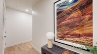 Located at 3333 S La Cienega Blvd in Los Angeles, this single-story residence showcases a thoughtfully designed contemporary interior with light hardwood flooring, recessed lighting, and a clean, neutral palette throughout. The entryway sets an inviting tone, featuring a console table accented by curated artwork and a globe table lamp, leading naturally into the main living areas.

The living room is bright and welcoming, with a large picture window framing lush garden views and allowing abundant natural light to fill the space. The kitchen is well-equipped with stainless steel appliances, including a refrigerator, range, and over-the-range microwave, complemented by two-tone cabinetry in warm wood and matte gray, a patterned tile backsplash, white quartz countertops, and a peninsula with bar seating.

The bedroom is a serene retreat, featuring a generously sized window overlooking greenery, light wood flooring, and a spacious walk-in closet outfitted with dual hanging rods. The bathrooms are finished with large-format neutral tile, soaking tub-shower combinations, white quartz vanities, and modern fixtures, creating a clean and spa-like atmosphere.

Throughout the residence, the design prioritizes open sight lines, natural light, and a cohesive modern aesthetic, making it a comfortable and functional home in a prime Los Angeles location.