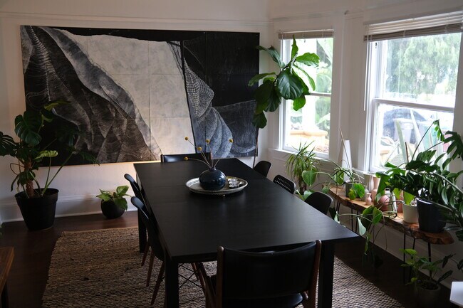 Front dining room with bay windows fits a nice size dining table - plenty of light for plants! - 877 53rd Street